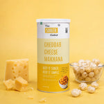 The Sober Habit Cheddar Cheese flavoured roasted makhana 70g canister with cheese blocks and fox nuts on yellow background
